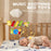 Baby lying in a crib with colorful music soothing bed toys above.
