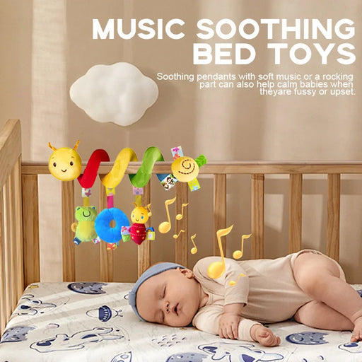 Baby lying in a crib with colorful music soothing bed toys above.
