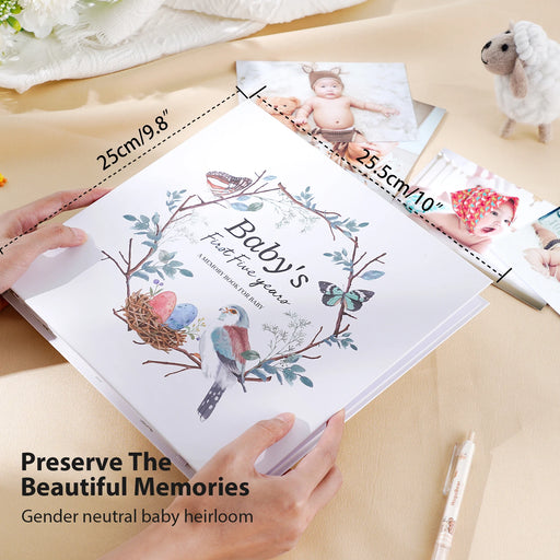 Baby memory book with decorative cover on a table with measurements and text.